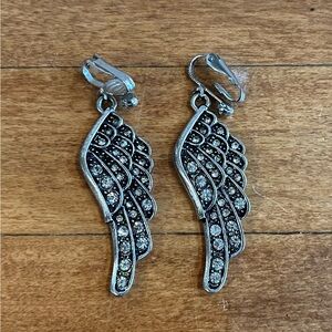Clip-on angel wing dangle earrings silver-plated finish and inlaid crystals.